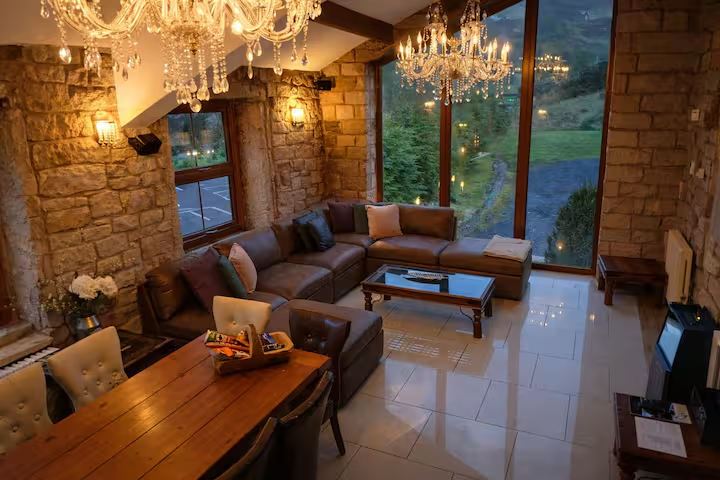 Elegant stone-walled lounge and dining space at Bird I’th Hand Country House